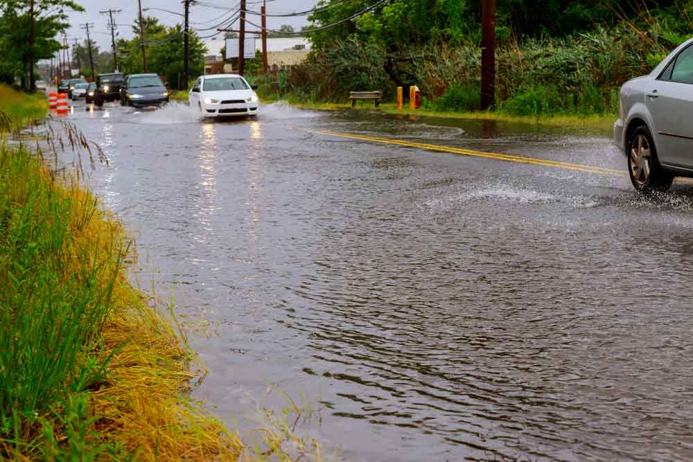 cars driving through flooded streets