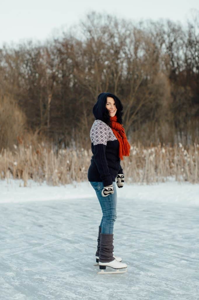 Happy woman learning to ice skate