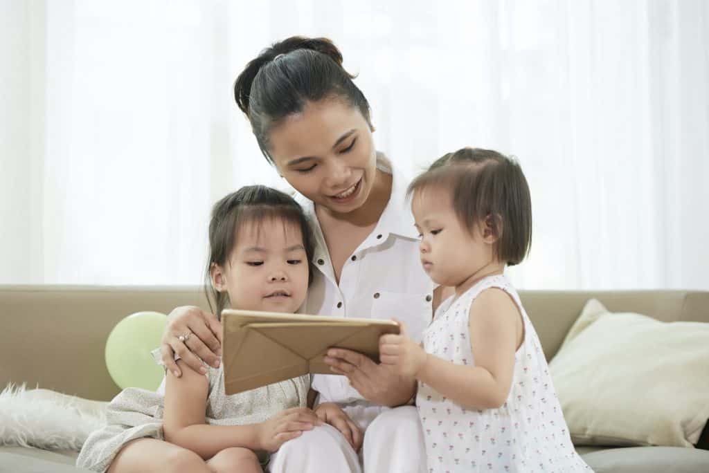 Woman Showing Educational Cartoon to Children